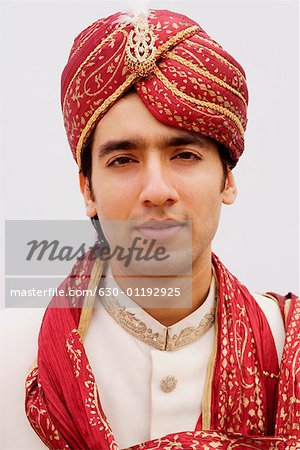 Portrait of a groom in a traditional wedding outfit
