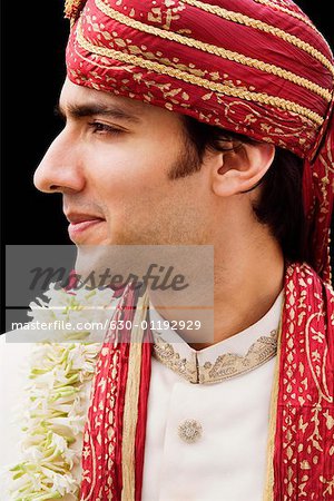 Close-up of a groom in a traditional wedding dress