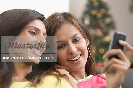 Close-up of two young women looking at a mobile phone