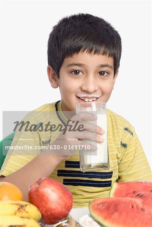 Close-up of a boy drinking a glass of milk