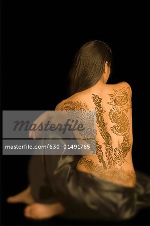 Rear view of a young woman with a tattoo on her back