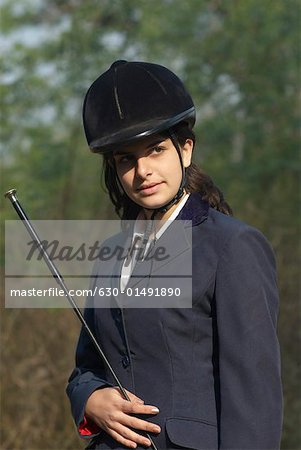 Close-up of a female jockey holding a riding crop