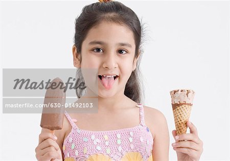 Portrait Of A Girl Holding Two Ice Creams Stock Photo Masterfile Premium Royalty Free Code 630