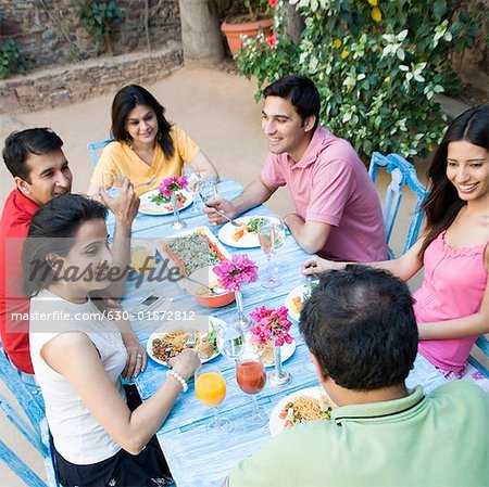 High angle view of a mid adult couple with their friends having food