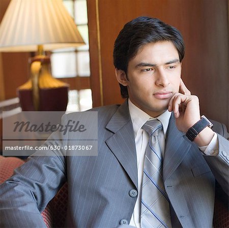 Businessman sitting with his hands on his chin