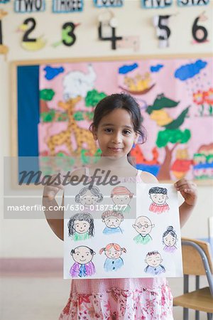 Portrait of a girl showing a drawing and smiling