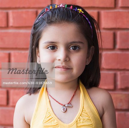 Portrait of a girl standing in front of a wall