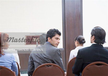 Group of business executives sitting on chairs in a meeting