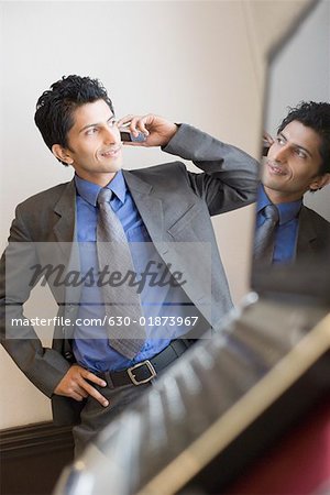 Businessman talking on a mobile phone and smiling