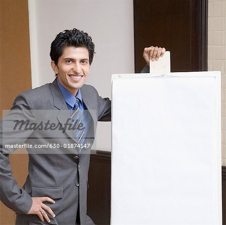 Portrait of a businessman standing near a whiteboard and smiling
