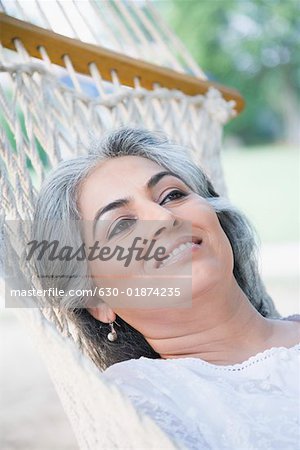 Close-up of a mature woman lying in a hammock