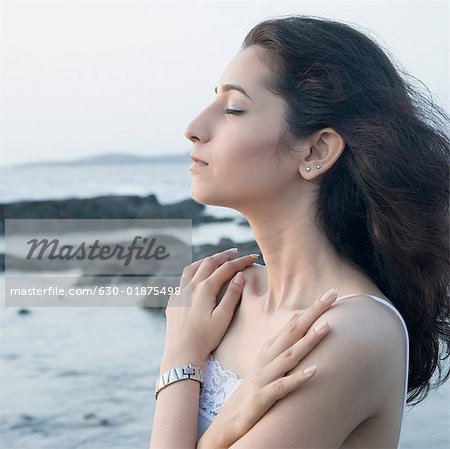 Side profile of a young woman thinking with her arms crossed