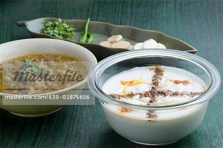 Close-up of two bowls of curry and curd