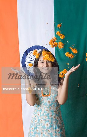 Portrait of a young woman standing in front of an Indian Flag