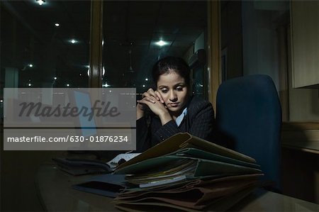 Businesswoman sitting in an office and thinking