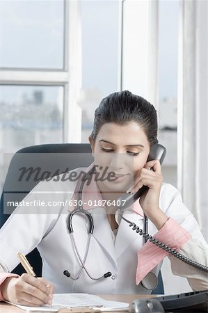 Close-up of a female doctor talking on the telephone