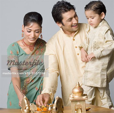 Couple with their son preparing for pooja