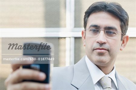 Close-up of a businessman holding a mobile phone