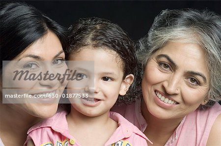 Portrait of a boy smiling with his mother and grandmother