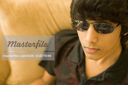 Close-up of a teenage boy wearing sunglasses - Stock Photo