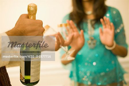 Close-up of a man's hand holding a champagne bottle