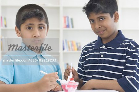 Portrait of two boys eating ice cream