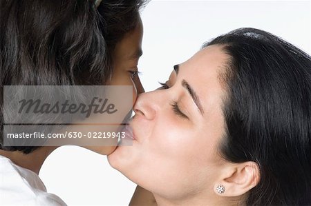 Close-up of a mid adult woman kissing her daughter