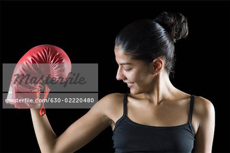 Portrait of a young woman flexing her muscles, Stock Photo