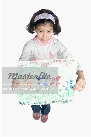 High angle view of a girl showing a drawing