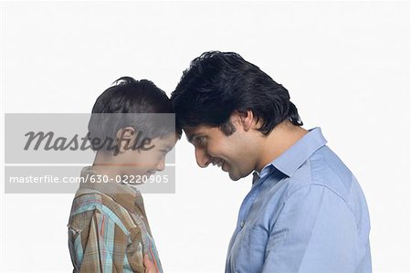 Side profile of a young man and his son face to face