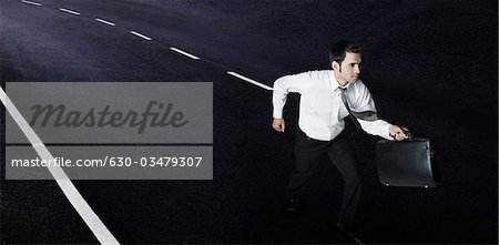 Businessman running on the road