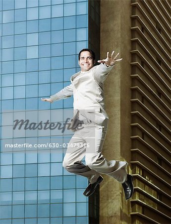 Businessman jumping with joy and smiling