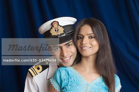 Close-up of a navy officer smiling with a teenage girl