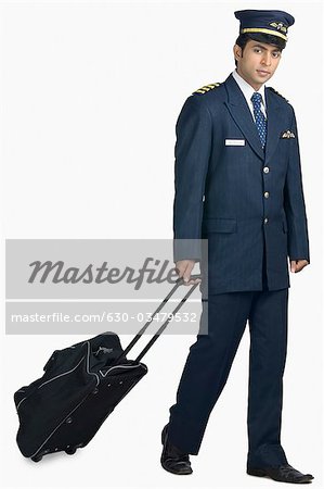 Portrait of a pilot carrying his luggage