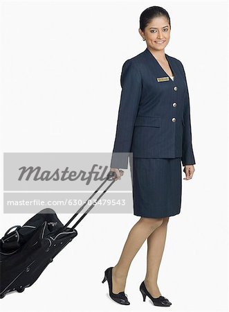 Portrait of an air hostess carrying her 