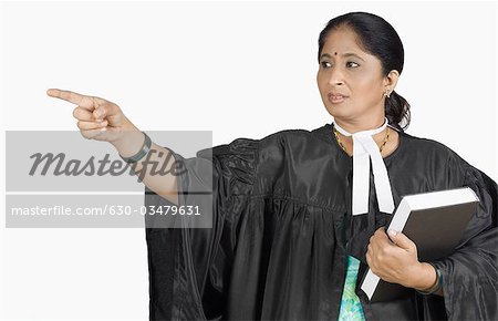 Female lawyer holding a book and pointing