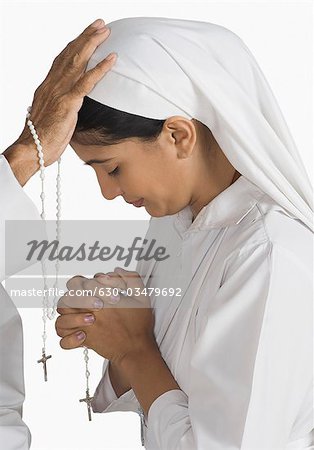 Nun confessing her sins to a priest Nun confessing her sins to a priest