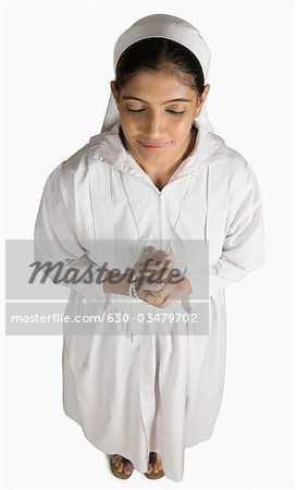 High angle view of a nun standing in a prayer position