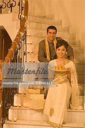 Couple sitting on a staircase and smiling