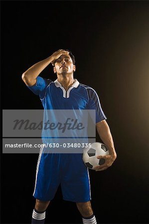 Soccer player heads ball on hi-res stock photography and images