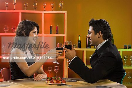 Couple toasting with wine in a bar
