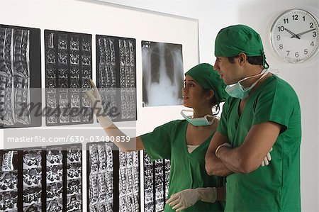 Female surgeon with a male surgeon examining an X-Ray report