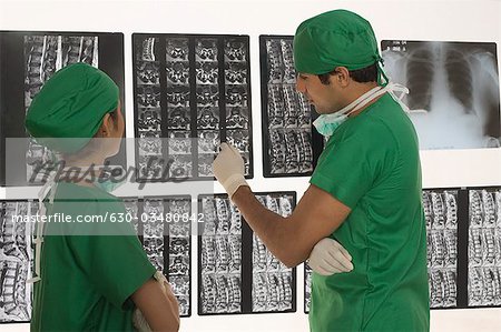 Female surgeon with a male surgeon examining an X-Ray report