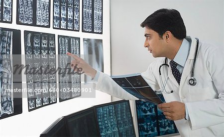 Male doctor examining X-Ray report