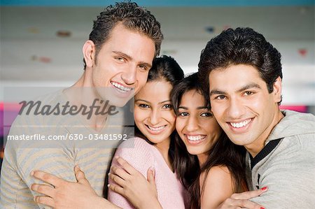 Two young couples in a bowling alley