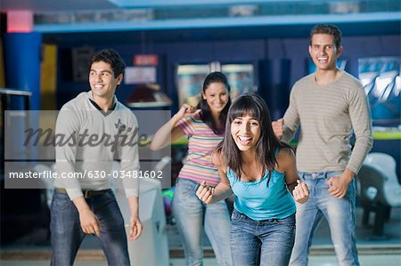 Two young couples in a bowling alley