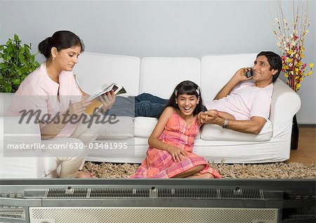 Portrait of a girl sitting with her parents and laughing