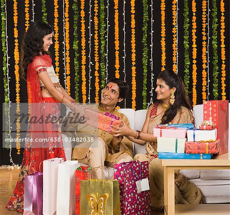 Couple giving gifts to their daughter on Diwali festival