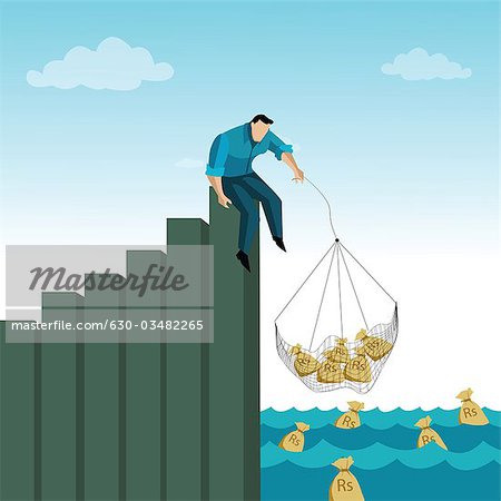 Man catching money bag from the river - Stock Photo - Masterfile
