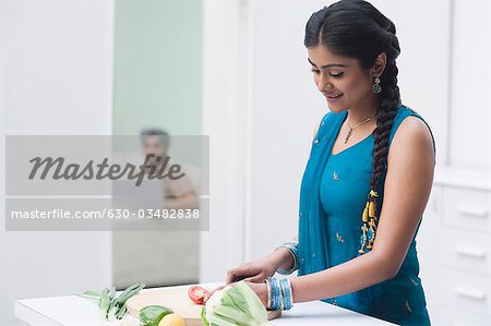 Woman chopping vegetables in the kitchen